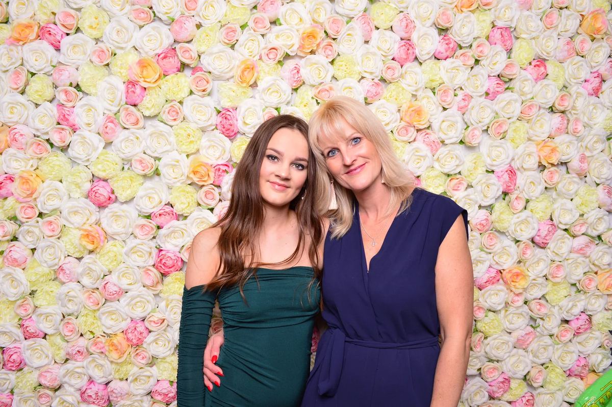 Wedding guests posing at the flower wall photo booth in Edinburgh