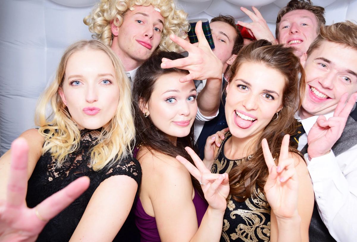 Guests in festive props having fun in a Bubble photo booth